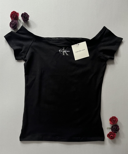 Podkreśl swoją kobiecość z czarną koszulką Calvin Klein Jeans typu off-shoulder. Elegancki dekolt odsłaniający ramiona i kultowe logo CK. Sprawdź naszą ofertę!